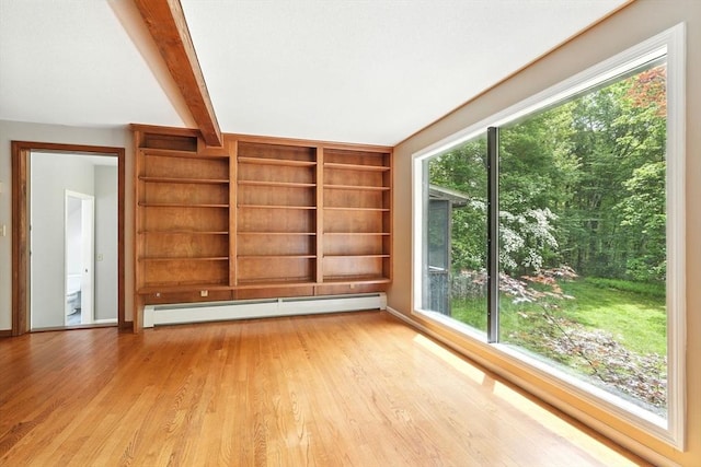 237 Shutesbury Rd, Amherst, MA 01002 - empty room featuring baseboard heating, light wood-style floors, plenty of natural light, beamed ceiling, and built in features