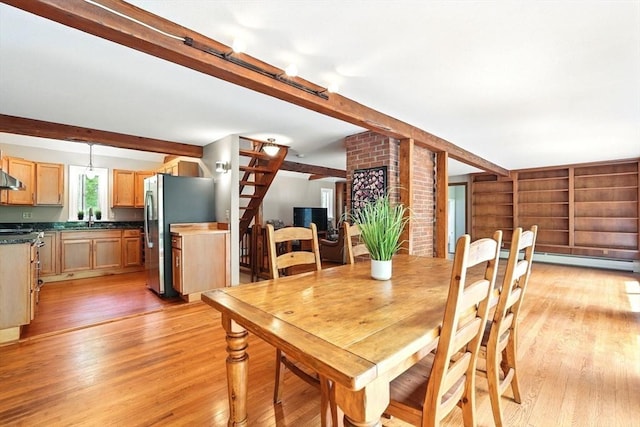 237 Shutesbury Rd, Amherst, MA 01002 - dining room featuring light wood finished floors, beam ceiling, and stairs