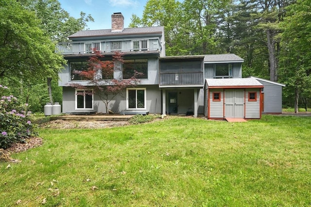 237 Shutesbury Rd, Amherst, MA 01002 - back of house with a balcony, a chimney, a yard, and an outdoor structure