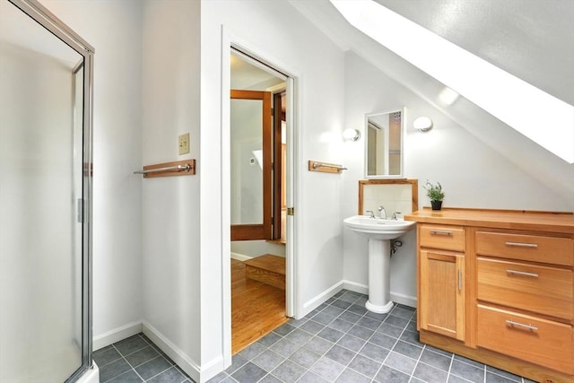 237 Shutesbury Rd, Amherst, MA 01002 - bathroom with a skylight, tile patterned flooring, a stall shower, a sink, and baseboards