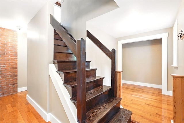 237 Shutesbury Rd, Amherst, MA 01002 - stairs with wood finished floors, baseboards, and brick wall