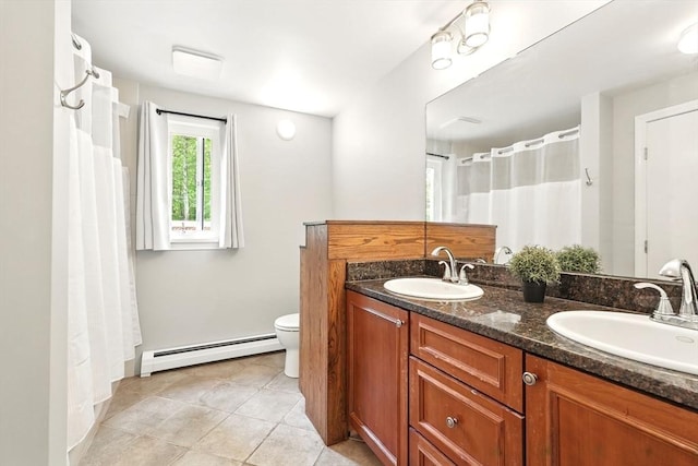 237 Shutesbury Rd, Amherst, MA 01002 - full bathroom with a baseboard heating unit, double vanity, toilet, tile patterned flooring, and baseboards