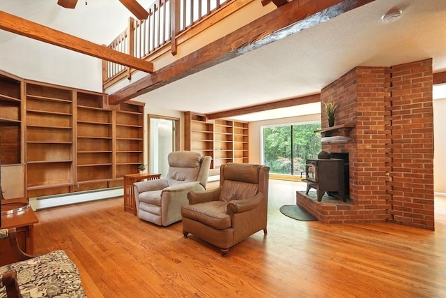 237 Shutesbury Rd, Amherst, MA 01002 - living room with baseboard heating, wood finished floors, ceiling fan, and built in shelves
