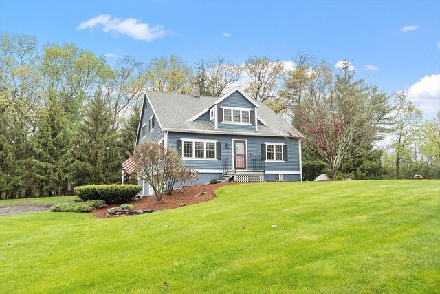 view of front facade featuring a front yard and a chimney