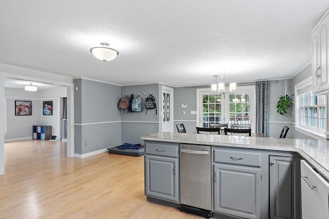 kitchen featuring gray cabinetry, a textured ceiling, light wood-style floors, a peninsula, and pendant lighting