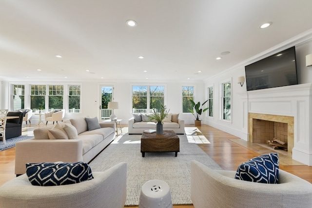 living room with crown molding and light hardwood / wood-style flooring