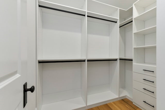 spacious closet with light hardwood / wood-style floors