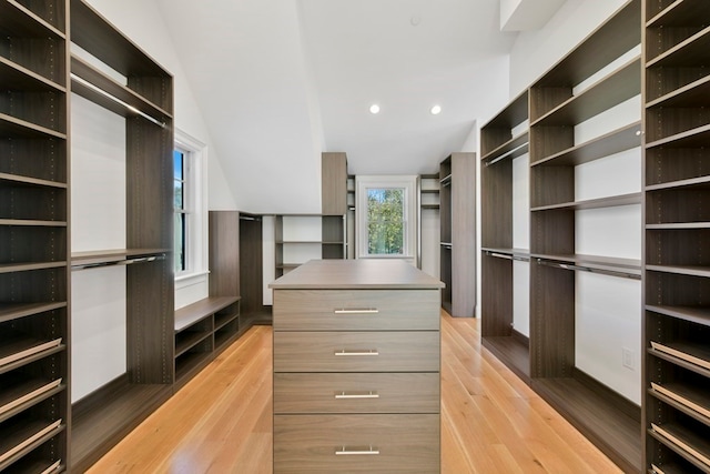 walk in closet with light hardwood / wood-style floors