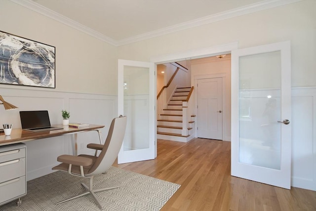 office space featuring french doors, light hardwood / wood-style floors, and crown molding