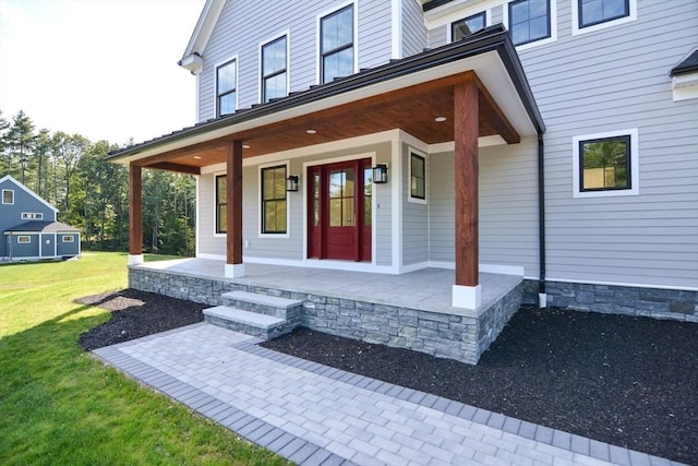 property entrance with a yard and a porch