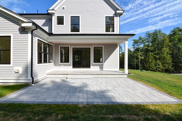 rear view of property with a lawn