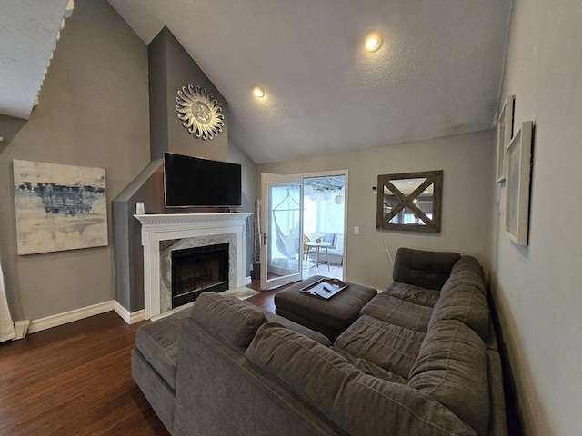 1559 Bay St Unit 53, Taunton, MA 02780 - living area featuring a high end fireplace, dark wood finished floors, vaulted ceiling, and baseboards
