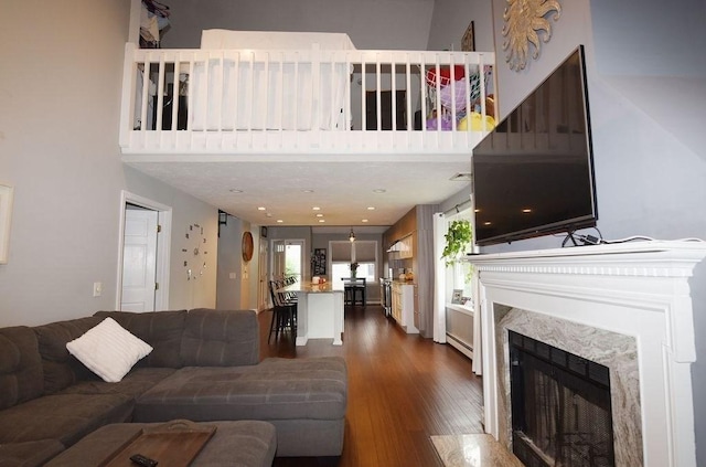 1559 Bay St Unit 53, Taunton, MA 02780 - living area featuring dark wood-style floors, a high end fireplace, and a towering ceiling
