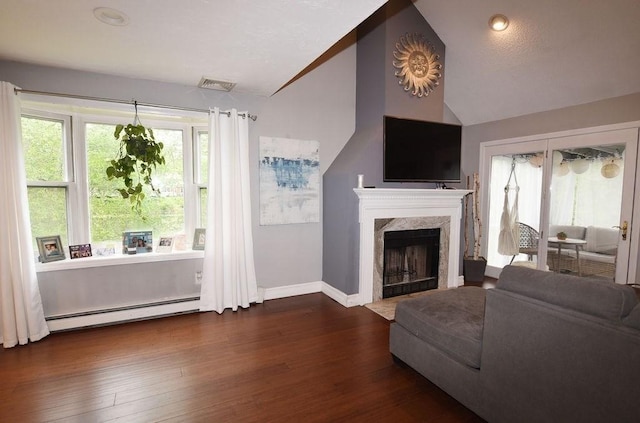 1559 Bay St Unit 53, Taunton, MA 02780 - living area with a baseboard radiator, lofted ceiling, baseboards, dark wood-style floors, and a premium fireplace