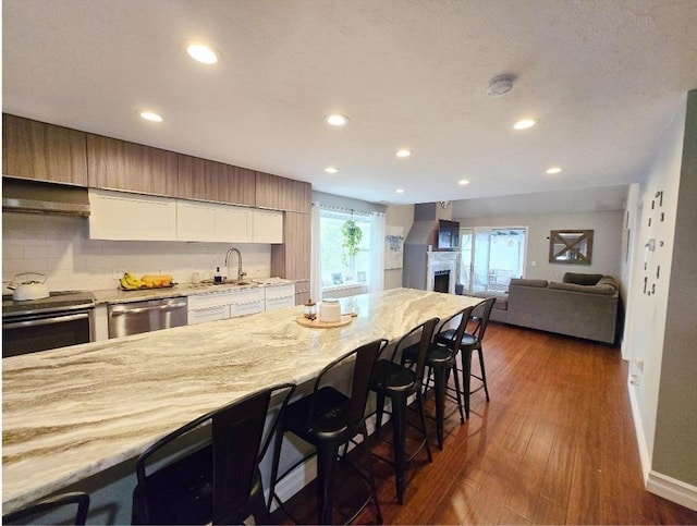 1559 Bay St Unit 53, Taunton, MA 02780 - kitchen with stainless steel appliances, a breakfast bar, a sink, extractor fan, and recessed lighting