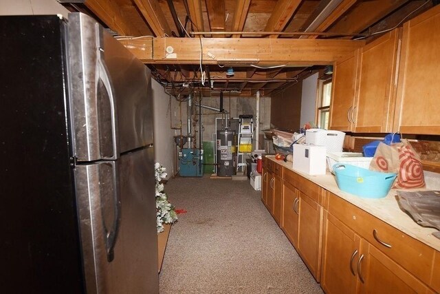 1559 Bay St Unit 53, Taunton, MA 02780 - unfinished below grade area featuring freestanding refrigerator, water heater, a heating unit, and light colored carpet