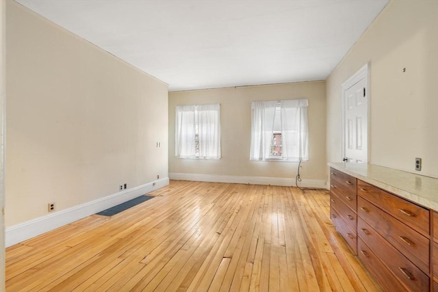 interior space with light wood-type flooring and baseboards