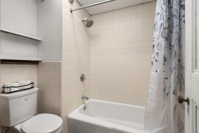 bathroom featuring wainscoting, tile walls, toilet, and shower / bath combo with shower curtain