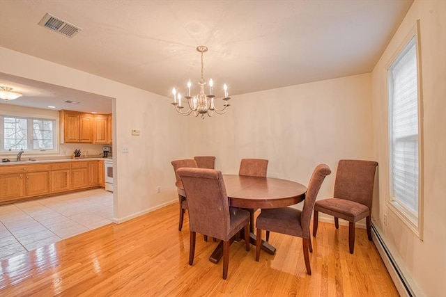 227 Village St, Millis, MA 02054 - dining room with light wood-style floors, visible vents, baseboard heating, and an inviting chandelier