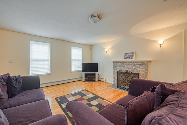 227 Village St, Millis, MA 02054 - living room featuring a brick fireplace, light wood finished floors, and baseboard heating