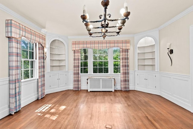 25 Hundreds Cir, Wellesley, MA 02481 - unfurnished dining area with radiator, crown molding, built in shelves, a chandelier, and plenty of natural light