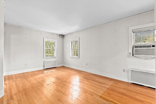 25 Hundreds Cir, Wellesley, MA 02481 - empty room featuring radiator, light wood-style floors, baseboards, and cooling unit