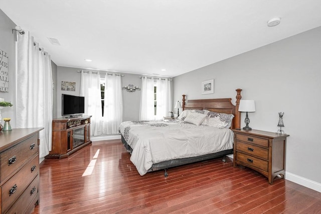 bedroom with recessed lighting, dark wood finished floors, visible vents, and baseboards