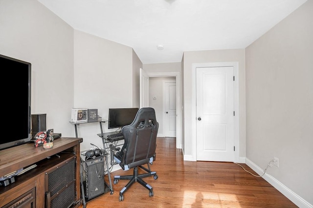 office space with baseboards and wood finished floors