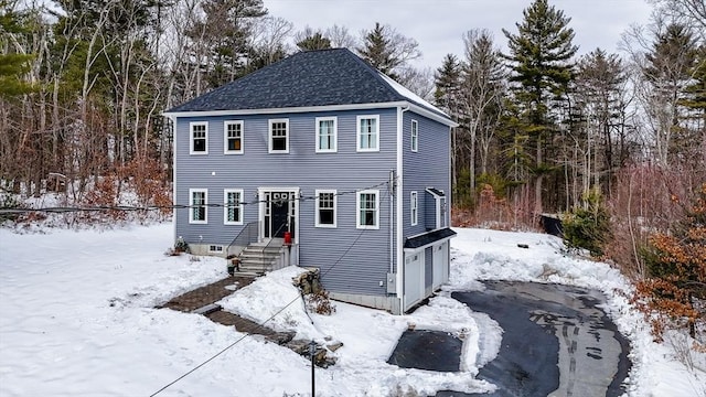 view of front of house with roof with shingles and an attached garage