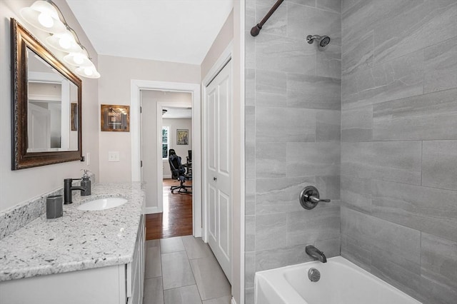 full bathroom featuring a closet, shower / bath combination, vanity, and baseboards