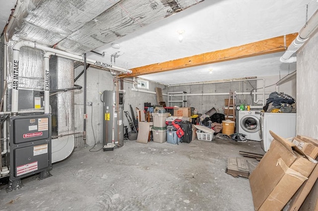 below grade area with a garage, heating unit, water heater, and washing machine and clothes dryer