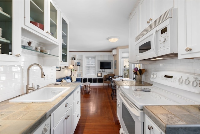 kitchen featuring white cabinets, white appliances, and sink