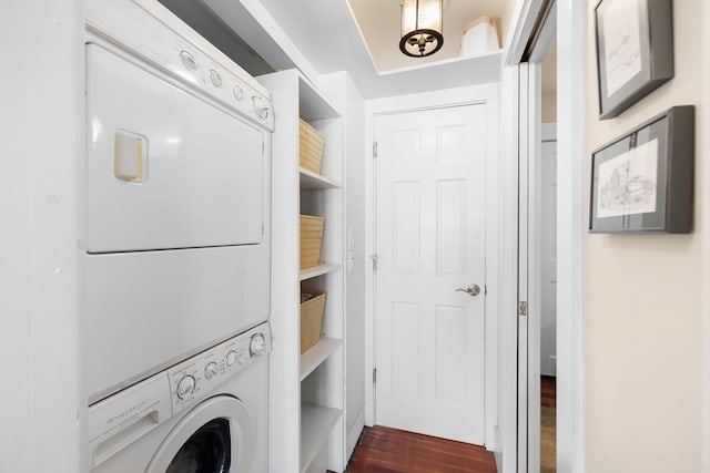 clothes washing area featuring dark hardwood / wood-style flooring and stacked washer and dryer