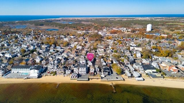 birds eye view of property featuring a water view and a beach view