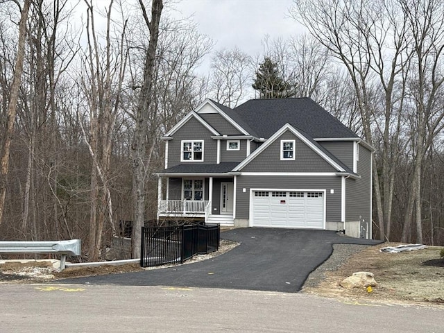 view of front of home featuring a garage, a porch, and aphalt driveway