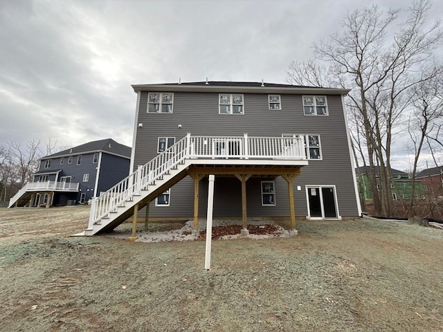 back of house with a deck and stairs