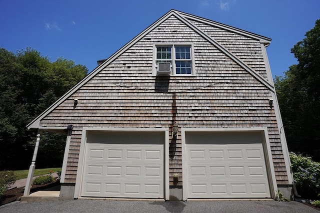 42 Wall St, Middleboro, MA 02346 - view of side of home with asphalt driveway, a garage, and cooling unit