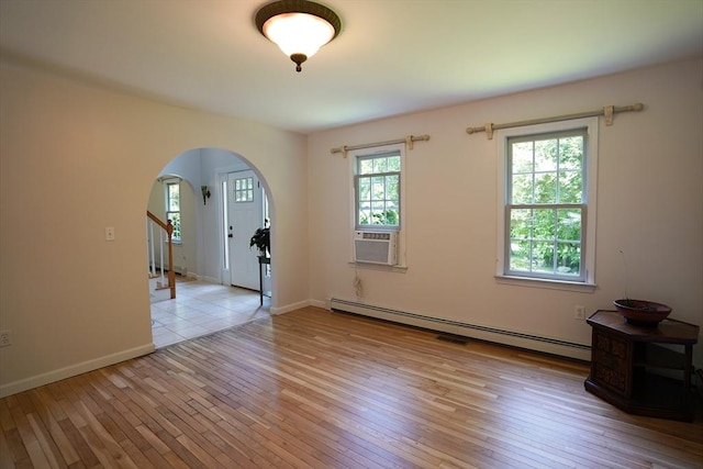 42 Wall St, Middleboro, MA 02346 - unfurnished room featuring baseboard heating, light wood-style flooring, arched walkways, and cooling unit