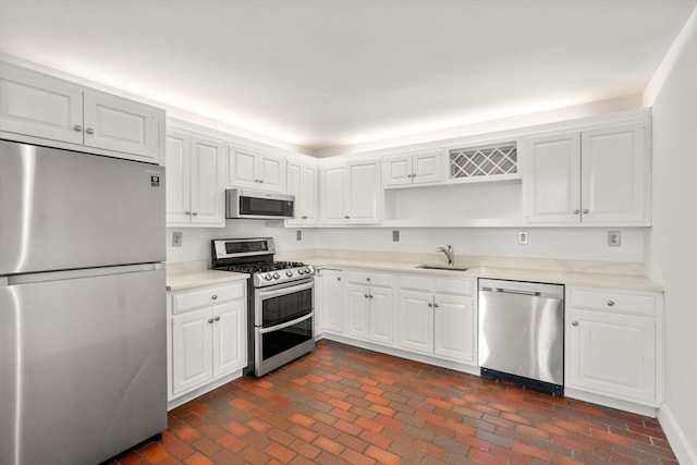 227 Summit Unit W207, Brookline, MA 02446 - kitchen featuring stainless steel appliances, open shelves, light countertops, and brick patterned flooring