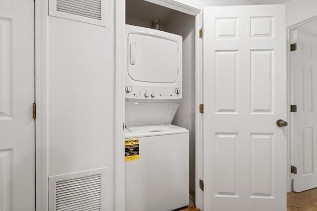 227 Summit Unit W207, Brookline, MA 02446 - laundry room with stacked washing machine and dryer and wood finished floors