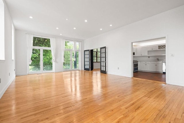 227 Summit Unit W207, Brookline, MA 02446 - unfurnished living room featuring light wood finished floors, recessed lighting, a sink, and baseboards