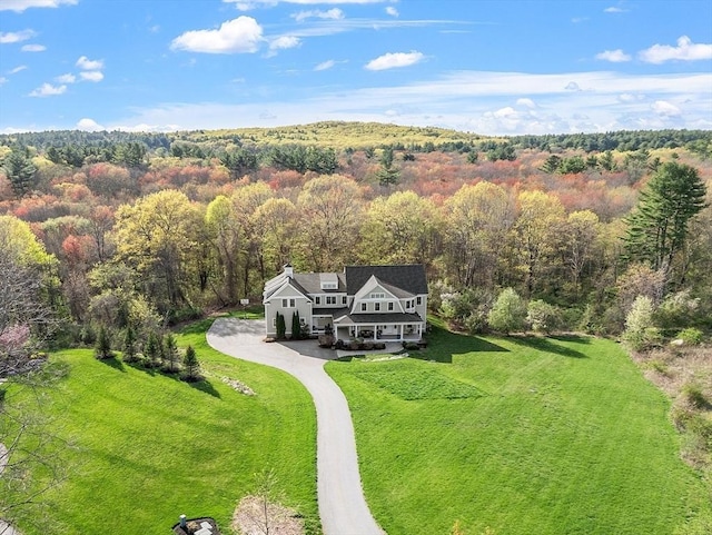 view of subject property featuring a forest