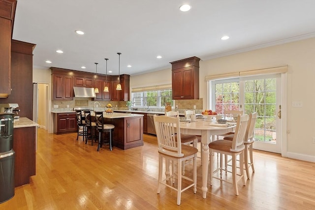 dining room with crown molding, light wood-type flooring, recessed lighting, and baseboards