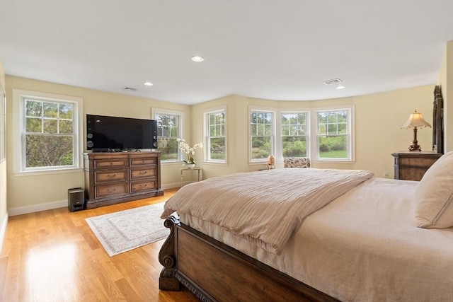 bedroom with light wood-style floors, baseboards, and recessed lighting