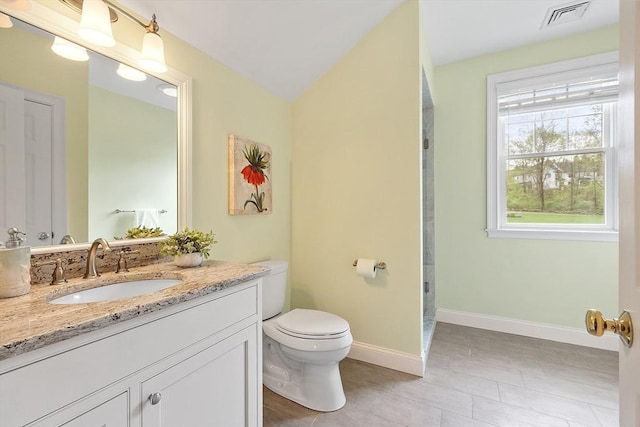 full bath featuring toilet, vanity, baseboards, and tile patterned floors