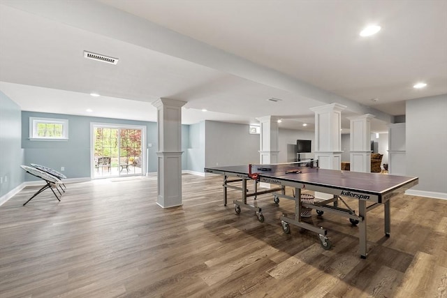 game room with decorative columns, baseboards, wood finished floors, and recessed lighting