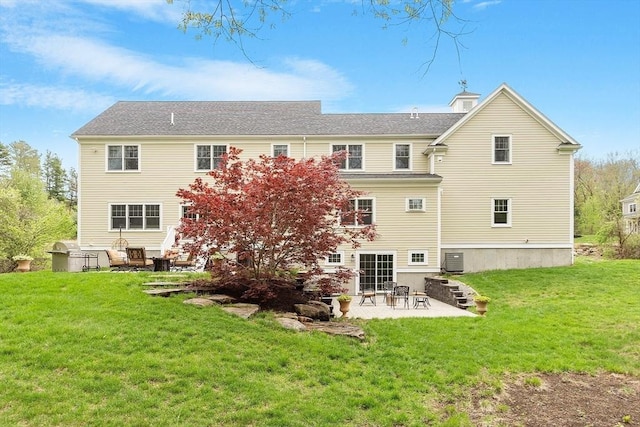 rear view of property with a patio, a lawn, and central AC unit