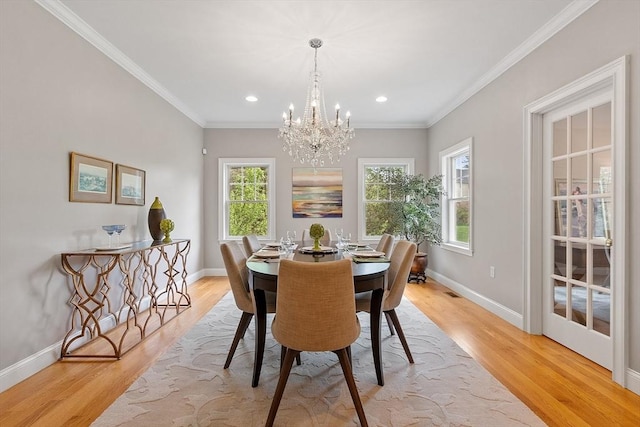 dining space with a chandelier, light wood-type flooring, baseboards, recessed lighting, and crown molding