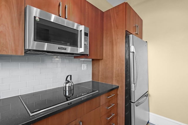 258 Shawmut Ave Unit 8, Boston, MA 02118 - kitchen with stainless steel appliances, brown cabinetry, backsplash, baseboards, and modern cabinets