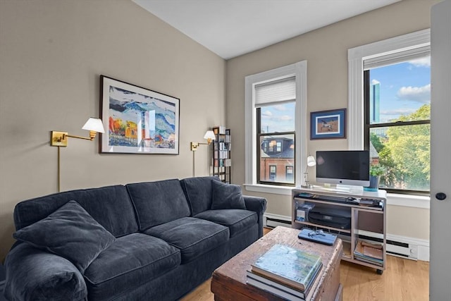 258 Shawmut Ave Unit 8, Boston, MA 02118 - living area featuring healthy amount of natural light, wood finished floors, baseboards, and a baseboard heating unit